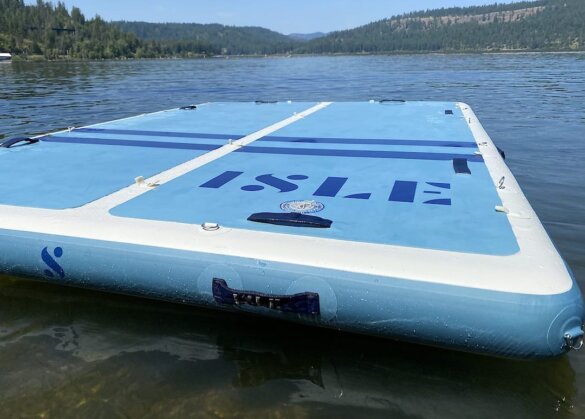 This review photo shows the ISLE Base Camp Dock inflated and floating on a lake.