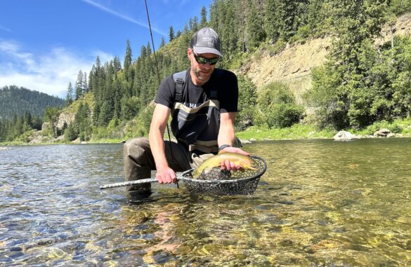 This review photo shows the author wearing the Smith Guide's Choice polarized sunglasses while testing them fly fishing on a river.