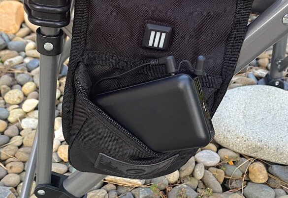 This review photo shows a closeup of the Terrain Heated Camping Chair battery and control pocket.