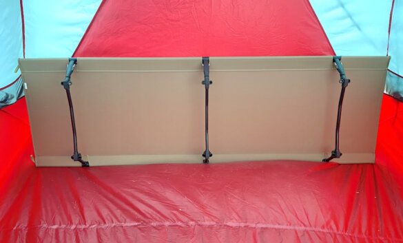 This review photo shows the Helinox Cot One Convertible cot from the bottom view inside a tent during the testing process.
