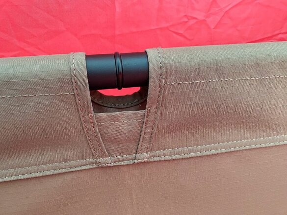 This photo shows a closeup of the Helinox Cot One Convertible side rail and fabric stitching.
