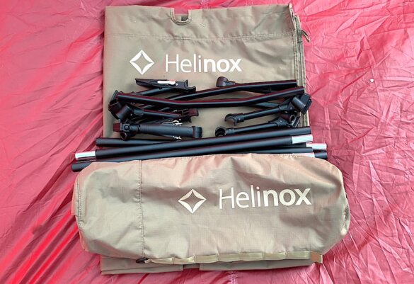 This testing and review photo shows the Helinox Cot One Convertible parts arrayed on the floor of camping tent before setup. 