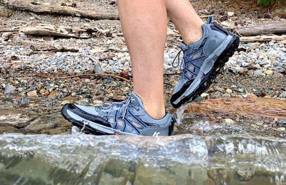 This photo shows the author wearing the Korkers All Axis Shoe in the water along a shoreline during the testing and review process.