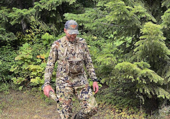 This photo shows the author evaluating the Sitka Core Merino 120 LS Crew base layer in the SubAlpine camo pattern version while wearing it on an Idaho elk hunt.