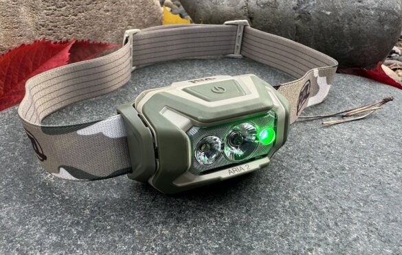 The Petzl Aria 2 headlamp for hunting tested by the author with its green light mode lit.