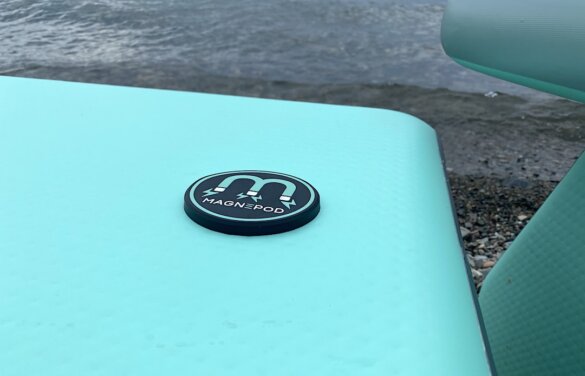 This photo shows a closeup of the built-in MAGNEPOD cup and accessory holder on the BOTE Inflatable Aero Table.