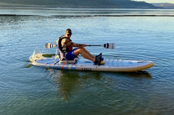 This photo shows the author paddling the ISLE Pioneer Pro in kayak mode on a lake during the review time period.