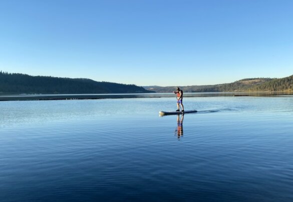This photo shows the author testing the ISLE Pioneer Pro inflatable standup paddle board on a lake during the review period.