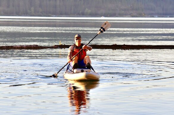 This photo shows the author paddling the ISLE Pioneer Pro in the kayak mode configuration during the testing and review process.