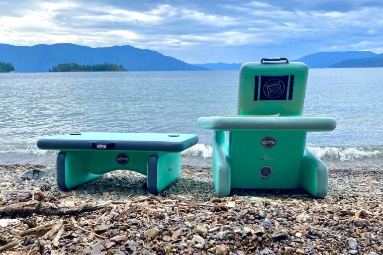 This review photo shows the BOTE Inflatable Aero Table on a beach next to an AeroRondak Chair.