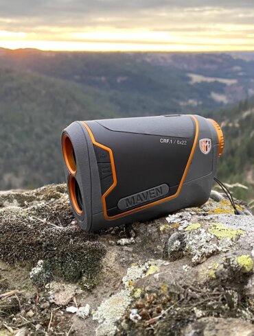 This review photo shows the Maven CRF.1 Rangefinder outside on a rock overlooking a forest during a hunting test.
