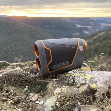 This review photo shows the Maven CRF.1 Rangefinder outside on a rock overlooking a forest during a hunting test.