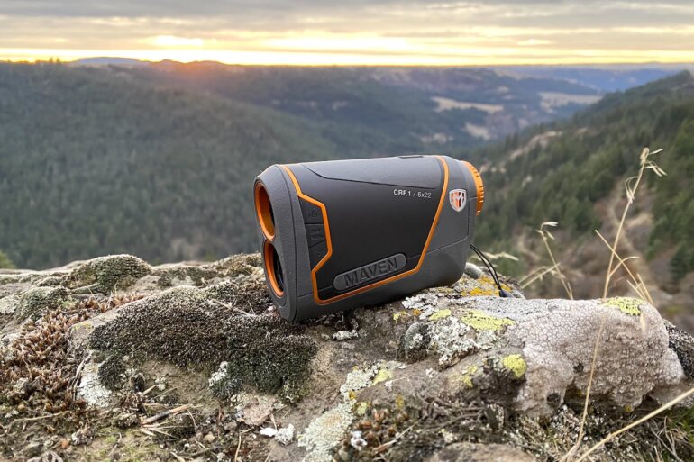 This review photo shows the Maven CRF.1 Rangefinder outside on a rock overlooking a forest during a hunting test.