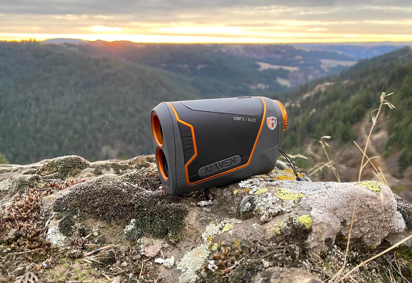This review photo shows the Maven CRF.1 Rangefinder outside on a rock overlooking a forest during a hunting test.