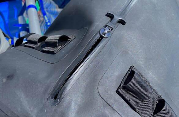 This review photo shows a closeup of the waterproof zipper on the Uncharted Supply Co The Vault 65L Duffel.