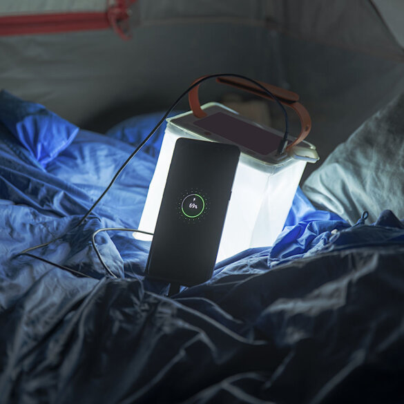 This Amazon Cyber Monday Deals and outdoor favorite gear picks shows the LuminAID PackLite Max 2-in-1 Camping Lantern and Phone Charger in a tent with a phone charging.
