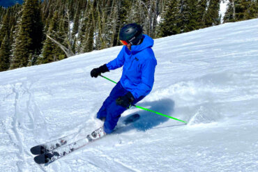 This photo shows the author wearing the Helly Hansen Odin 9 Worlds Jacket while skiing.