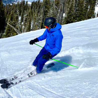 This photo shows the author wearing the Helly Hansen Odin 9 Worlds Jacket while skiing.