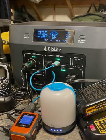 This portable power station and solar generator buying guide photo shows the BioLite BaseCharge 600 with multiple electronic devices being charged by the BaseCharge 600.