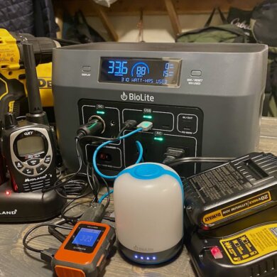 This portable power station and solar generator buying guide photo shows the BioLite BaseCharge 600 with multiple electronic devices being charged by the BaseCharge 600.