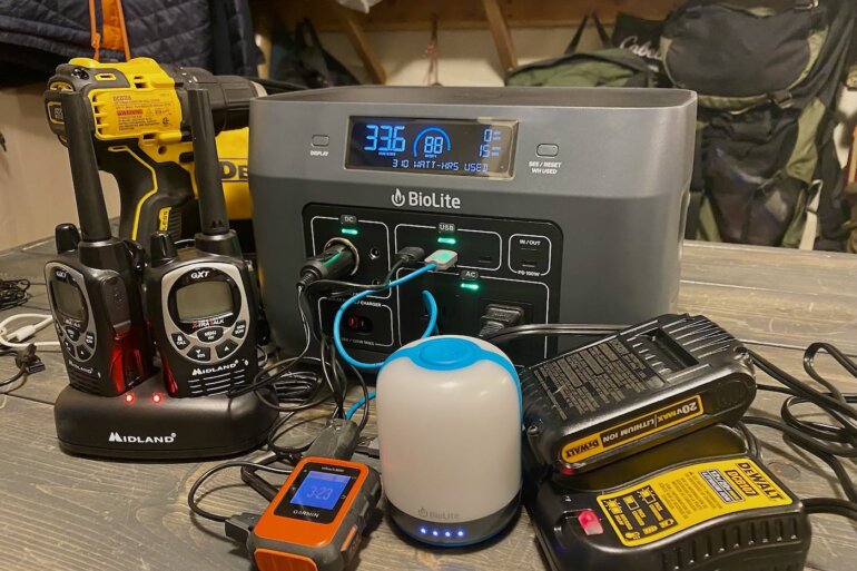 This portable power station and solar generator buying guide photo shows the BioLite BaseCharge 600 with multiple electronic devices being charged by the BaseCharge 600.