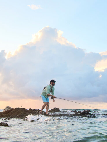 This photo shows a fly fisherman fishing in the ocean with a new Orvis Helios Fly Rod.