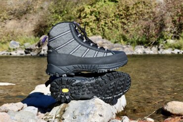 This review photo shows the Patagonia Forra Wading Boots on a rock near a river during the testing process.