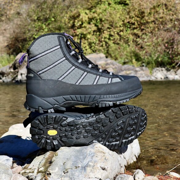 This review photo shows the Patagonia Forra Wading Boots on a rock near a river during the testing process.