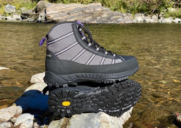 This photo shows the men's Patagonia Forra Wading Boots next to a river.
