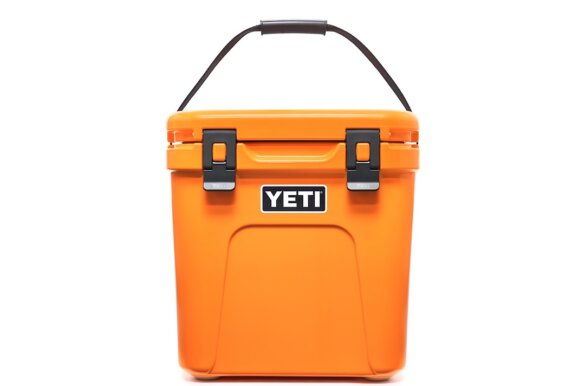 This product photo shows the YETI Roadie 24 Hard Cooler in the King Crab Orange color option.