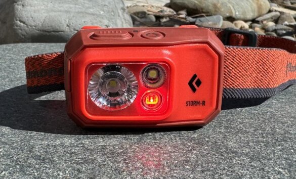 This photo shows the RGB lens with the red mode activated on the Black Diamond Storm 500-R Headlamp.