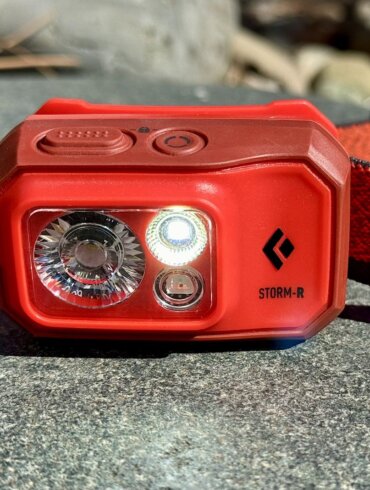 This review photo shows the Black Diamond Storm 500-R Headlamp with a light turned on.
