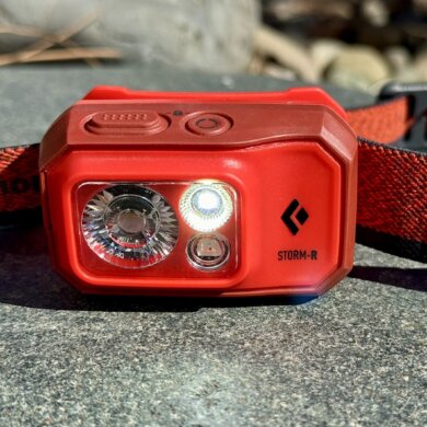 This review photo shows the Black Diamond Storm 500-R Headlamp with a light turned on.