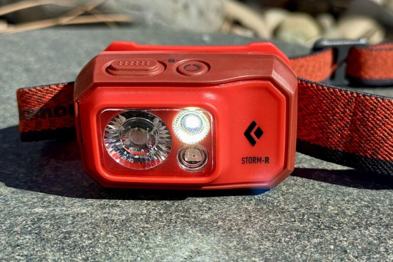 This review photo shows the Black Diamond Storm 500-R Headlamp with a light turned on.