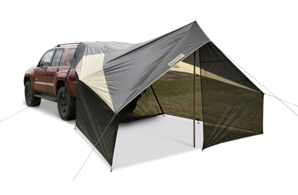 This product photo shows the Kelty Waypoint Screenhouse Tarp attacked to the back of an SUV vehicle.