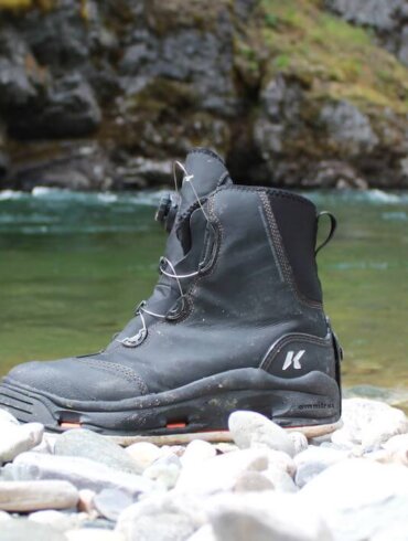 This field-tested review photo shows the Korkers Devil's Canyon Wading Boots near a river.