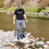 This photo shows the author wearing the Vertx Cutback Technical Pants during near a river during the testing and review process.