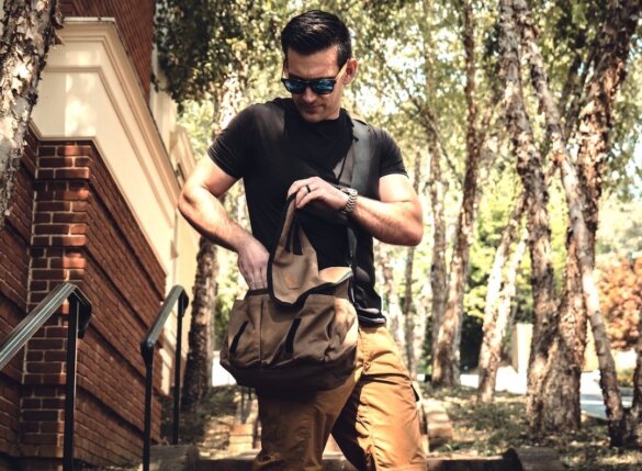 Man with White Duck Outdoors Filios Messenger Bag.
