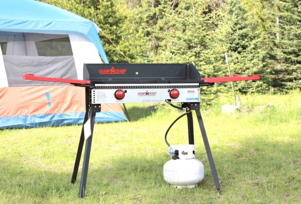 Camp Chef Pro 14 60X series 2-burner freestanding camp stove set up with propane tank at a camp site ready for use testing.