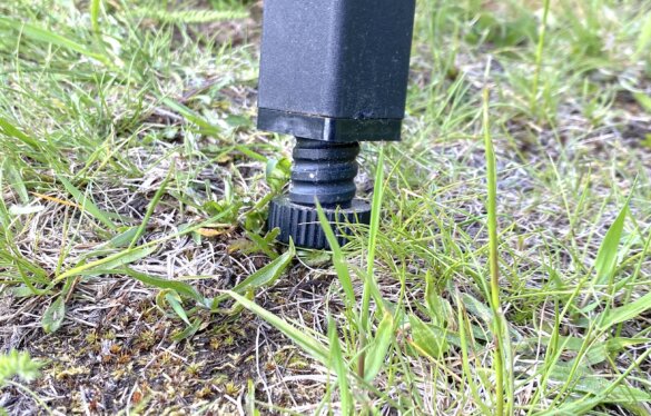 Closeup of adjustable height camp stove leg.