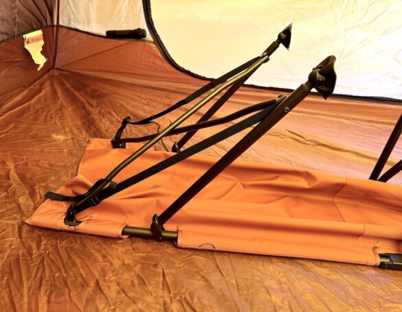 The head end of the cot legs partially extended. 