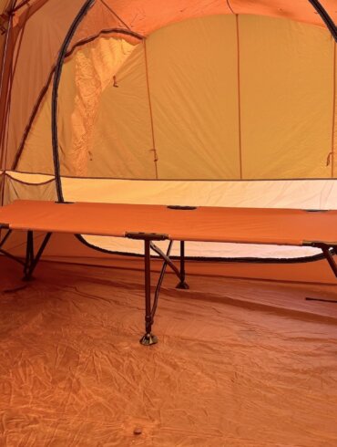 REI Co-op Campwell Folding Cot set up inside of a camping tent.