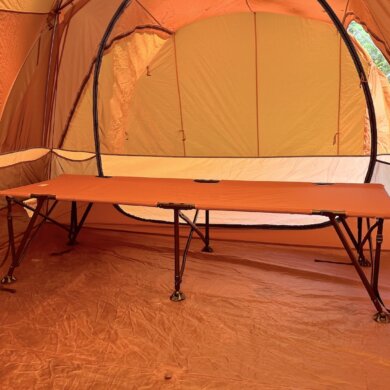 REI Co-op Campwell Folding Cot set up inside of a camping tent.