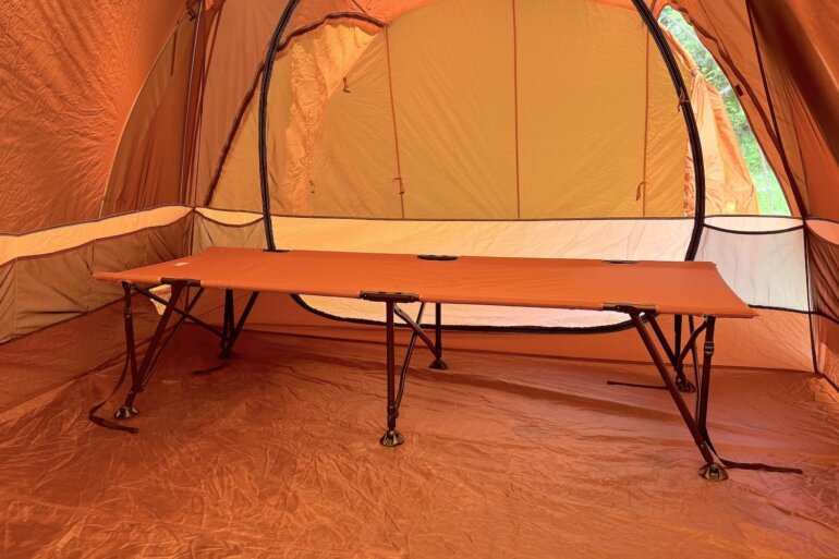 REI Co-op Campwell Folding Cot set up inside of a camping tent.