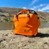 RUX Soft Cooler Bag on a sandy beach.