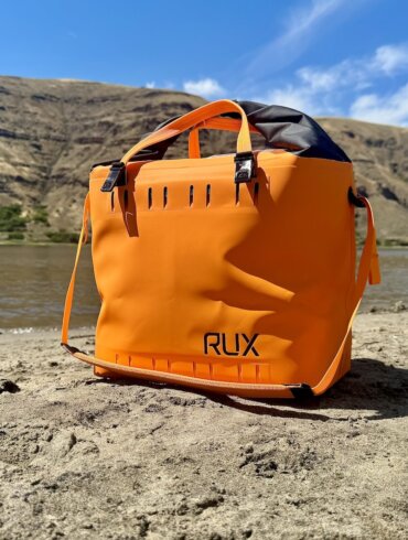 RUX Soft Cooler Bag on a sandy beach.