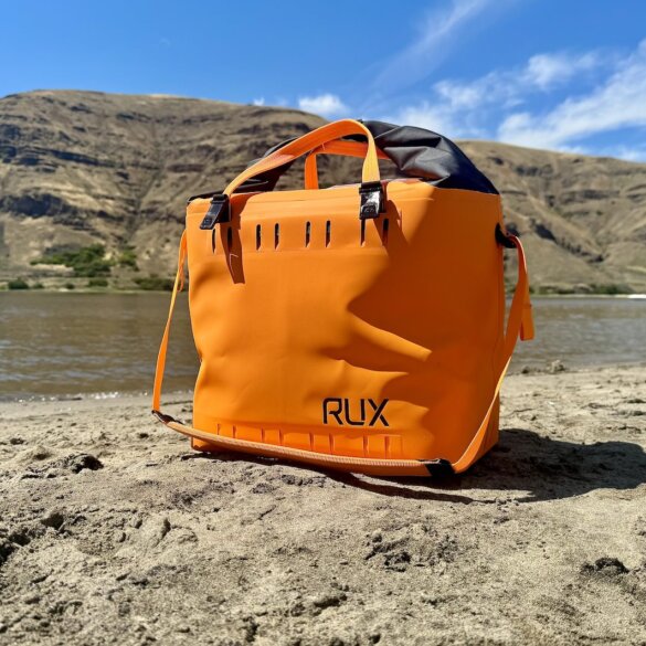 RUX Soft Cooler Bag on a sandy beach.