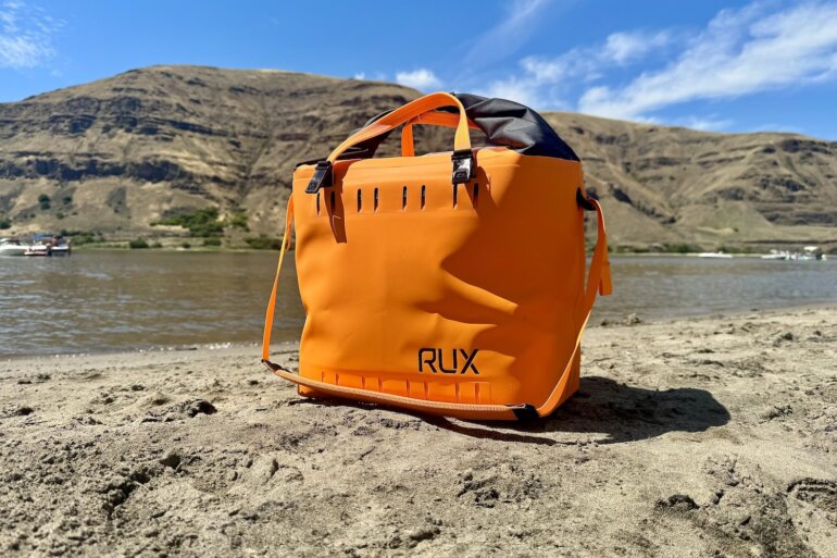 RUX Soft Cooler Bag on a sandy beach.