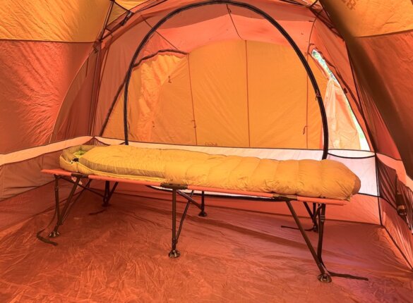REI Co-op Campwell Folding Cot with sleeping bag on top.