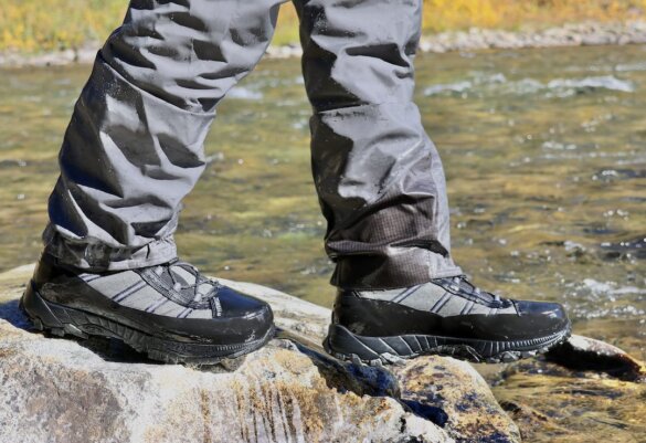 Author wearing Forra wading boots on a rock near a river.
